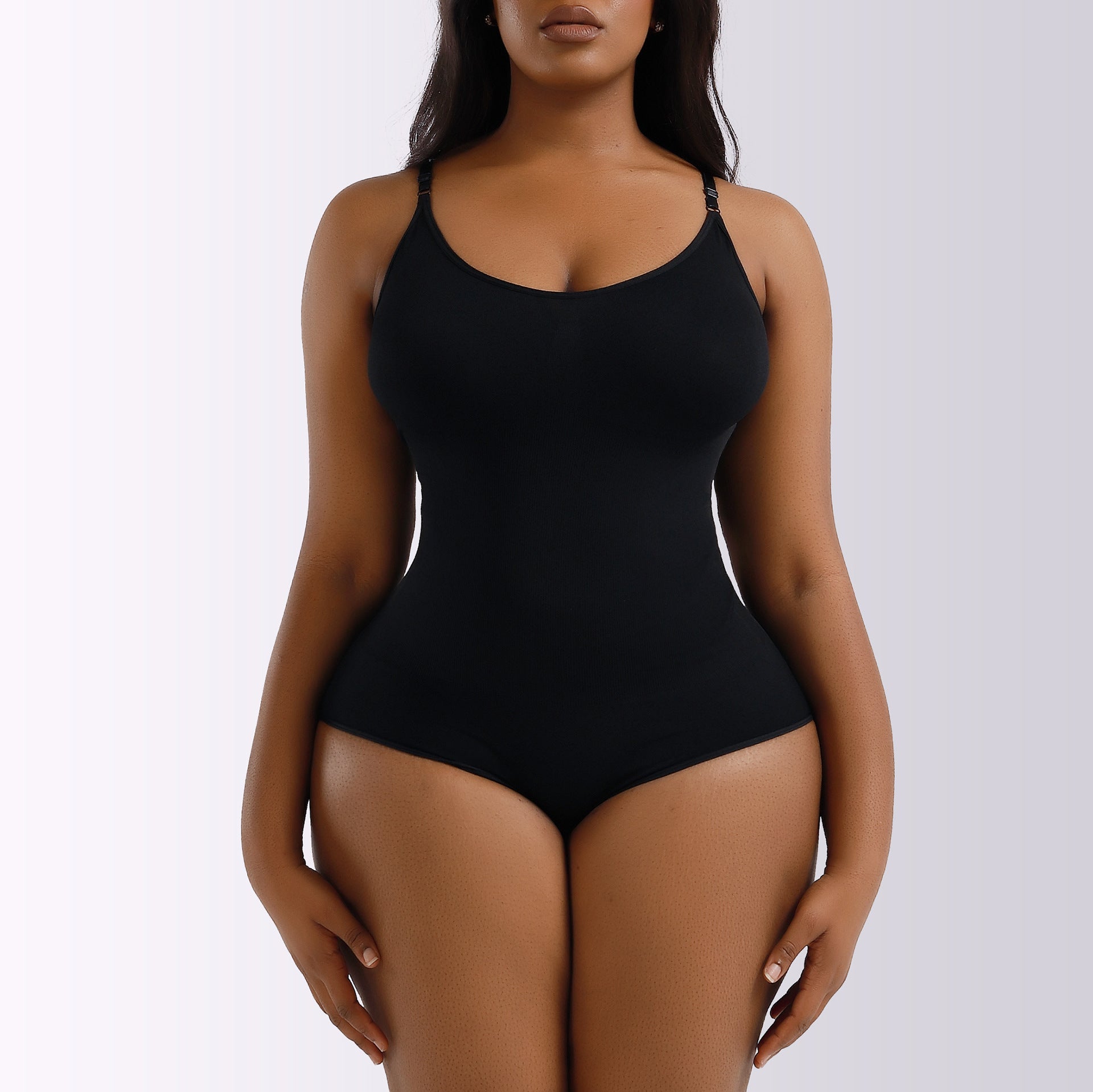 a woman in a black bodysuit posing for the camera