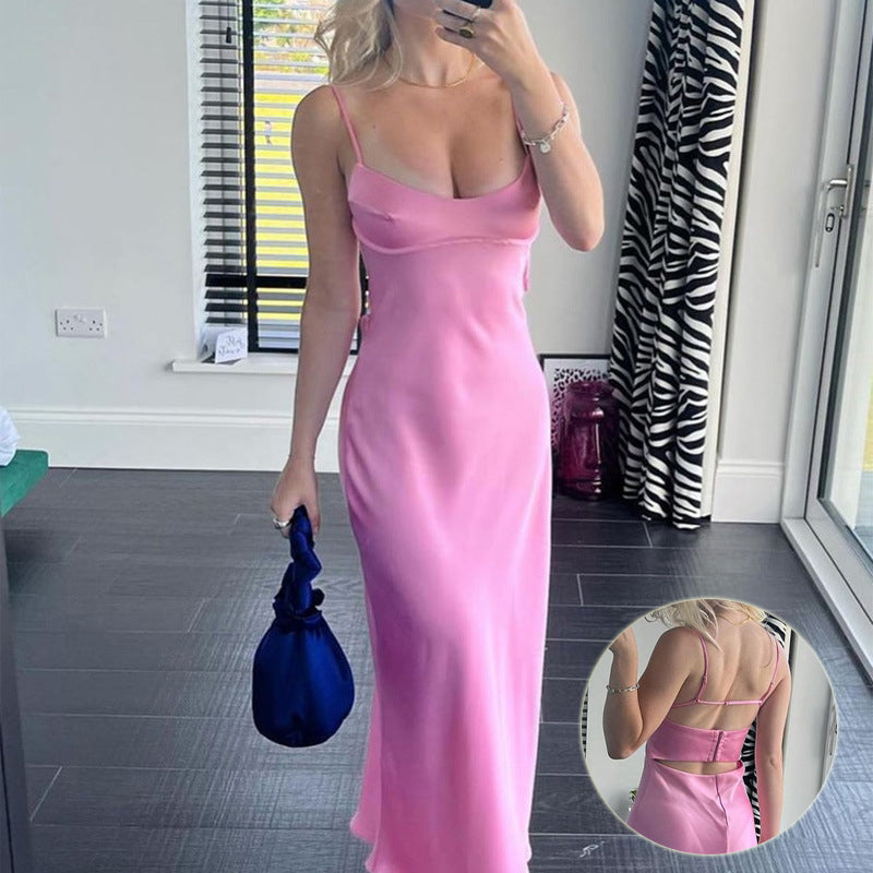 a woman in a pink dress taking a selfie