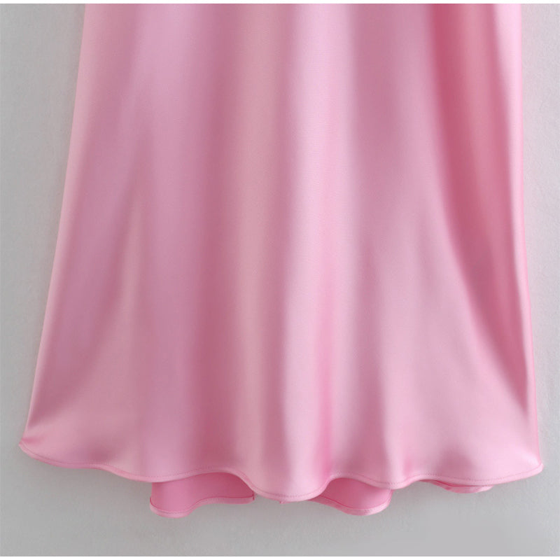 a pink dress hanging on a wall