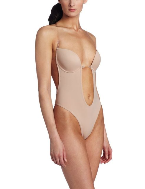 a woman wearing a nude bodysuit with a cut out side