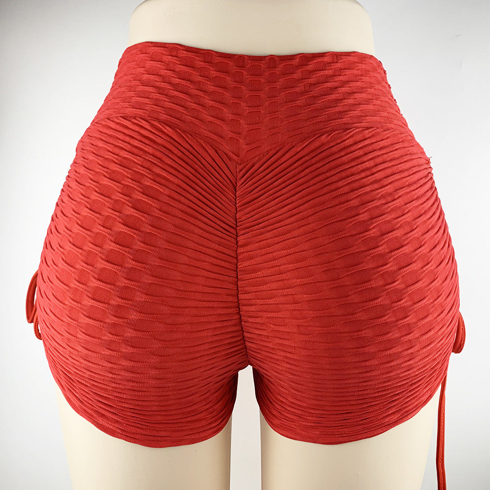 a close up of a woman's red shorts