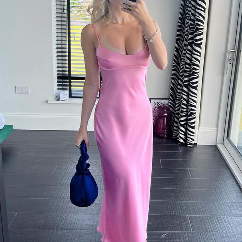 a woman in a pink dress taking a selfie